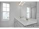 Bathroom featuring double vanity, modern fixtures, and a large mirror at 3932 Well Fleet Drive, Fuquay Varina, NC 27526