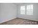 Bright bedroom with neutral carpet, two windows, base molding, and neutral walls at 3932 Well Fleet Drive, Fuquay Varina, NC 27526