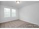 Bright, carpeted bedroom with a large window, ready for personalization at 3932 Well Fleet Drive, Fuquay Varina, NC 27526