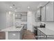 Modern kitchen with gray cabinets, granite countertops, and island at 3932 Well Fleet Drive, Fuquay Varina, NC 27526