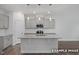 Modern kitchen featuring an island, stainless steel appliances, and pendant lighting at 3932 Well Fleet Drive, Fuquay Varina, NC 27526