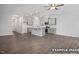 Open-concept living space with hardwood floors, neutral colors, and modern kitchen with island at 3932 Well Fleet Drive, Fuquay Varina, NC 27526