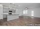 Spacious open-concept living area featuring hardwood floors and bright kitchen at 3932 Well Fleet Drive, Fuquay Varina, NC 27526