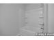 Bright bathroom featuring a shower and tub combination with a shower head and shelving at 3932 Well Fleet Drive, Fuquay Varina, NC 27526