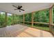 Covered back porch with wood flooring, open framed walls and a ceiling fan for outdoor comfort at 40 Moonraker Dr, Spring Hope, NC 27882