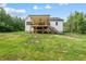 Exterior of home featuring a white facade, backyard and a covered porch with stairs at 40 Moonraker Dr, Spring Hope, NC 27882
