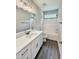 Bathroom featuring white cabinets, hard wood style floors, bathtub, and a mirror at 40 Moonraker Dr, Spring Hope, NC 27882