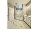 Elegant bathroom with double vanity, sleek mirrors, marble floors and a spacious, modern walk-in shower at 40 Moonraker Dr, Spring Hope, NC 27882