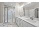 Bright bathroom featuring double vanity with modern sinks and a glass shower with white marble patterned tile at 40 Moonraker Dr, Spring Hope, NC 27882