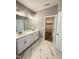 Modern bathroom boasts double vanity, elegant tile flooring, and access to the walk-in closet at 40 Moonraker Dr, Spring Hope, NC 27882
