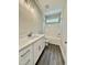 Modern bathroom with white vanity, sleek fixtures, and a shower-tub combination under a transom window at 40 Moonraker Dr, Spring Hope, NC 27882