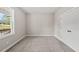 Neutral bedroom with plush carpeting, a double door closet, and a bright window overlooking the yard at 40 Moonraker Dr, Spring Hope, NC 27882