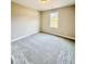 A new bedroom with neutral walls, carpet, and a window with a view of the lawn at 40 Moonraker Dr, Spring Hope, NC 27882