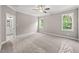 A bright bedroom with plush carpeting and bright windows overlooking the surrounding nature at 40 Moonraker Dr, Spring Hope, NC 27882