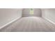 An empty bedroom with light-colored walls and carpet, featuring a window for natural light at 40 Moonraker Dr, Spring Hope, NC 27882