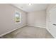 Neutral bedroom with plush carpeting, a double door closet, and a bright window overlooking the yard at 40 Moonraker Dr, Spring Hope, NC 27882