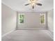 Neutral bedroom with plush carpeting and windows that offer natural light and views of the backyard at 40 Moonraker Dr, Spring Hope, NC 27882