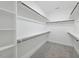 Walk-in closet with carpet and white shelving and multiple hanging rods for clothing storage at 40 Moonraker Dr, Spring Hope, NC 27882