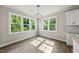 Bright dining area featuring lots of natural light from windows overlooking the surrounding trees and modern light fixtures at 40 Moonraker Dr, Spring Hope, NC 27882