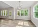 Bright dining room with large windows, stylish light fixture, hardwood floors and outdoor access at 40 Moonraker Dr, Spring Hope, NC 27882