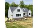 New construction home with a two car garage, white siding, black shutters and landscaped flower beds at 40 Moonraker Dr, Spring Hope, NC 27882