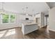 Modern kitchen with white cabinets, granite countertops, stainless steel appliances, and an island with bar seating at 40 Moonraker Dr, Spring Hope, NC 27882