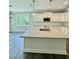 A stylish kitchen featuring white cabinets, stainless steel appliances, and granite countertops at 40 Moonraker Dr, Spring Hope, NC 27882