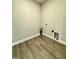 Laundry room features wood floors, utility hookups and base trim at 40 Moonraker Dr, Spring Hope, NC 27882