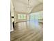 Bright living room with a fireplace, many windows, and luxury vinyl plank floors at 40 Moonraker Dr, Spring Hope, NC 27882
