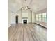Spacious living room with a vaulted ceiling, wood floors, fireplace, and large windows at 40 Moonraker Dr, Spring Hope, NC 27882