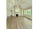 Cozy living room featuring a fireplace, a ceiling fan, and luxury vinyl plank floors at 40 Moonraker Dr, Spring Hope, NC 27882