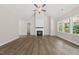 Bright living room with vaulted ceilings, a cozy fireplace, hardwood floors, and scenic backyard views at 40 Moonraker Dr, Spring Hope, NC 27882