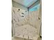 Modern shower with marble tiling, niche storage, and dual shower heads, showcasing premium finishes at 40 Moonraker Dr, Spring Hope, NC 27882