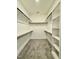 Spacious walk-in closet features carpeted floors, shelving and hanging rods at 40 Moonraker Dr, Spring Hope, NC 27882