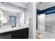 Well-lit bathroom with a vanity, sink, and a view into a separate area with a bathtub and shower at 42 Melstone Turn, Durham, NC 27707