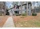Two-story condominium with an American flag, gray siding, and a concrete walkway at 42 Melstone Turn, Durham, NC 27707