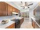 Well-lit kitchen featuring wooden cabinets, modern appliances, and a view into the sunny dining area at 42 Melstone Turn, Durham, NC 27707