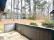 Outdoor patio area with wooded backdrop, offering a private and tranquil space at 42 Melstone Turn, Durham, NC 27707