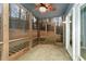 Screened porch with ceiling fan and view of wooded backyard offers a relaxing outdoor space at 42 Melstone Turn, Durham, NC 27707