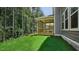 The backyard features a covered back porch offering a peaceful setting with wooded views at 7537 Percussion Dr, Apex, NC 27539