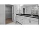 Bathroom with double vanity, dark countertop and walk in closet at 7537 Percussion Dr, Apex, NC 27539