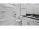 Clean, bright bathroom with white cabinets, gray countertops, a tub and shower combo, and tile floors at 7537 Percussion Dr, Apex, NC 27539