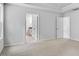 Bedroom showcases neutral carpet, two windows, and entry to the en-suite bathroom at 7537 Percussion Dr, Apex, NC 27539