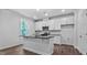 Bright kitchen with white cabinets, a central island, and stainless steel appliances at 7537 Percussion Dr, Apex, NC 27539
