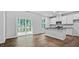 Well-lit kitchen with white cabinets, an island and stainless steel appliances at 7537 Percussion Dr, Apex, NC 27539