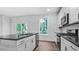 A kitchen featuring white cabinetry, stainless steel appliances, and sleek countertops at 7537 Percussion Dr, Apex, NC 27539