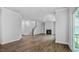 Open living room with hardwood floors and a fireplace creating a warm and inviting space at 7537 Percussion Dr, Apex, NC 27539