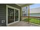 Covered patio with wood floors, sliding door, and views to backyard at 7537 Percussion Dr, Apex, NC 27539