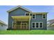 The backyard shows the charming home exterior with a covered porch and multiple windows at 7537 Percussion Dr, Apex, NC 27539