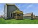 The spacious yard displays the back of the house with a lovely covered porch at 7537 Percussion Dr, Apex, NC 27539